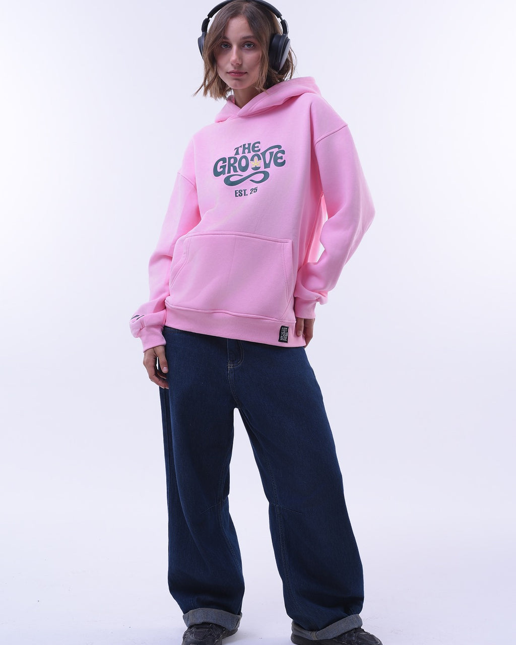 NYS pink oversized hoodie for women with front pocket and graphic text worn with dark jeans