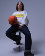 NotYourSize2025 oversized crewneck sweatshirt white with yellow text worn by woman holding basketball