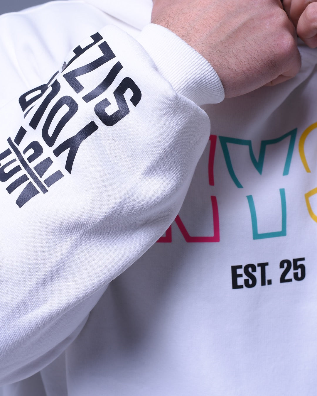 White oversized hoodie for unisex with bold black text on sleeve and colorful design on front